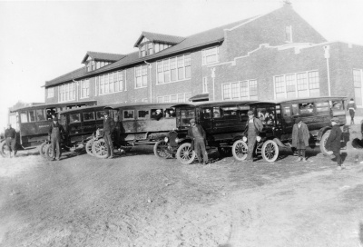 School buses lined up in front of the school.